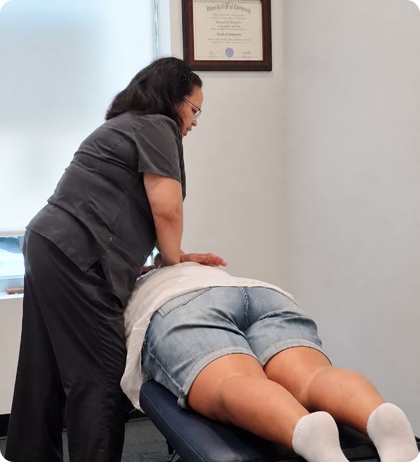 Dr. Shepherd adjusting a patient's lower back on a treatment table