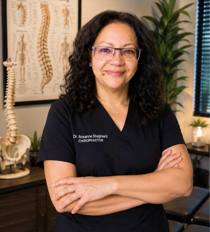 Dr. Roxanne Shepherd, chiropractor, standing with arms crossed in her Vero Beach office